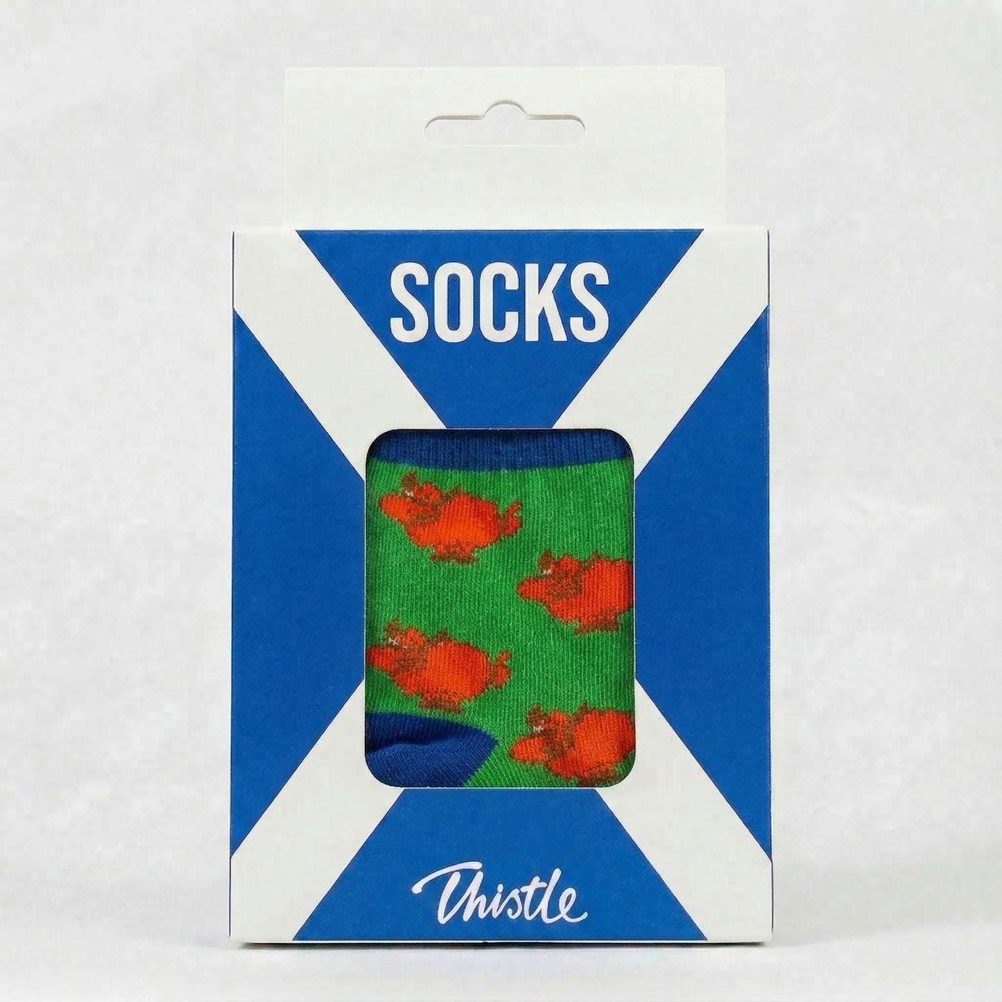 Packaged socks with cow pattern on green background
