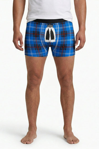 Man wearing blue tartan boxers with traditional sporran on a white background.