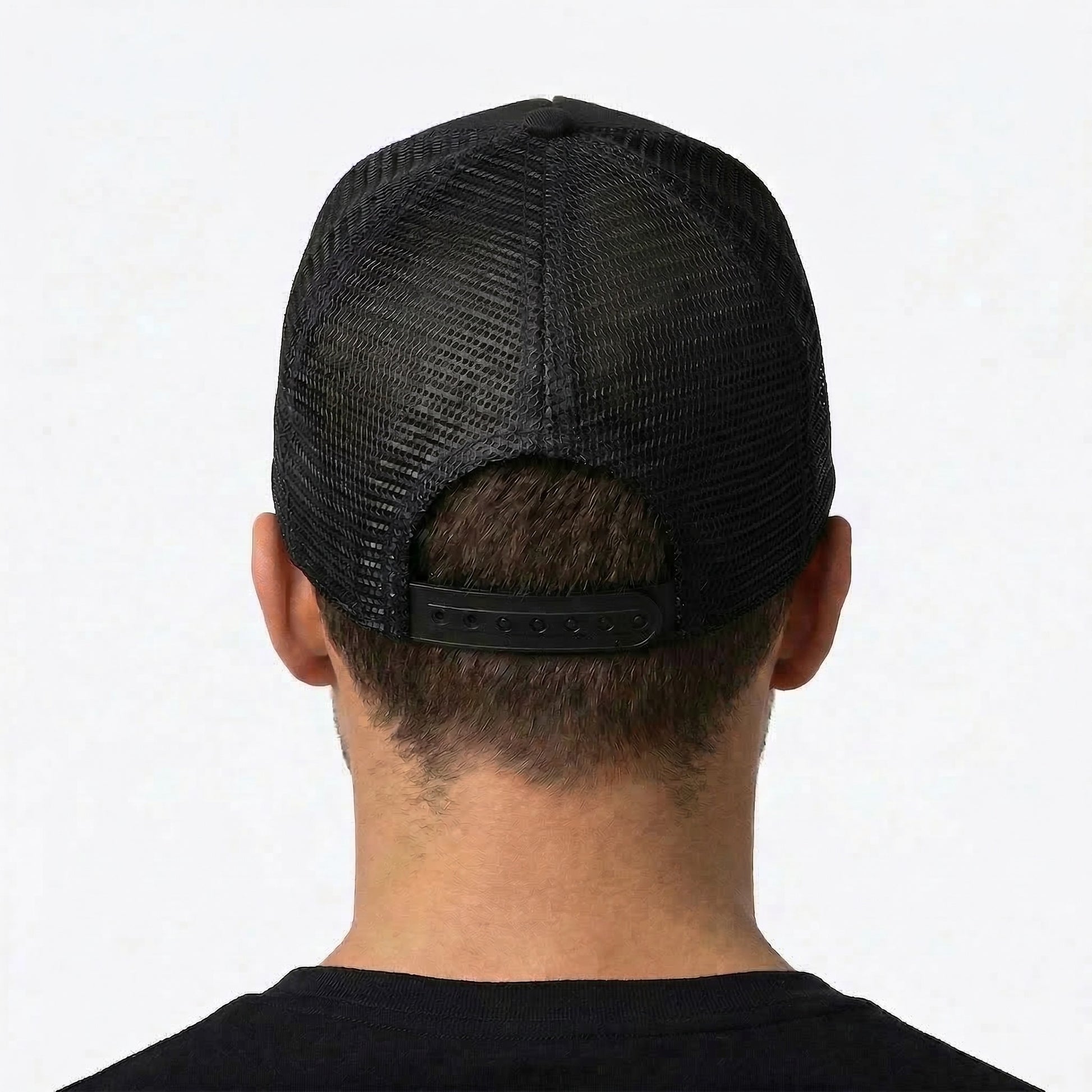 Black mesh cap worn by a person on a white background