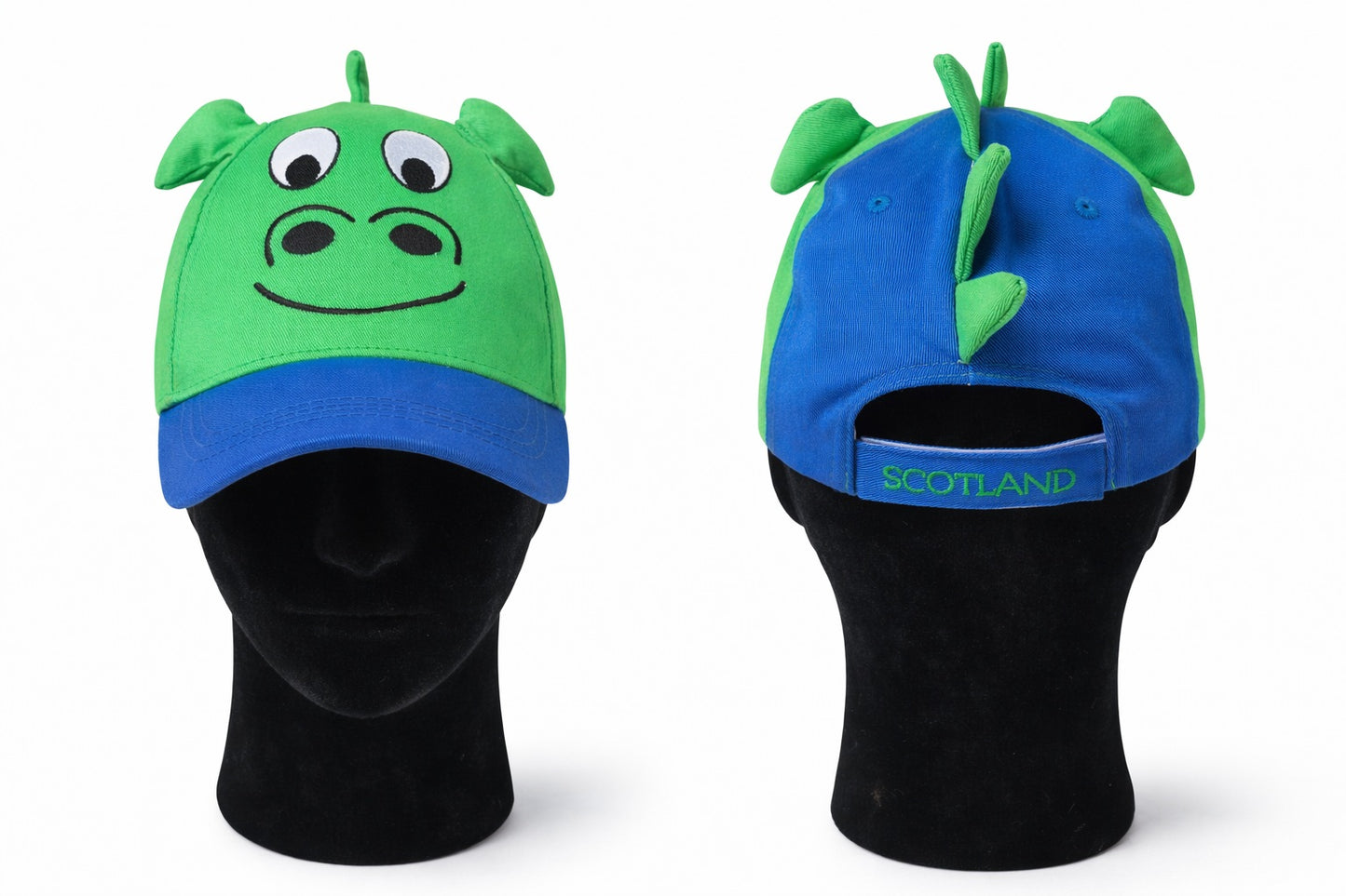 Two novelty hats, one green and blue with a nessie design, the same hat flipped round, on black mannequin heads.