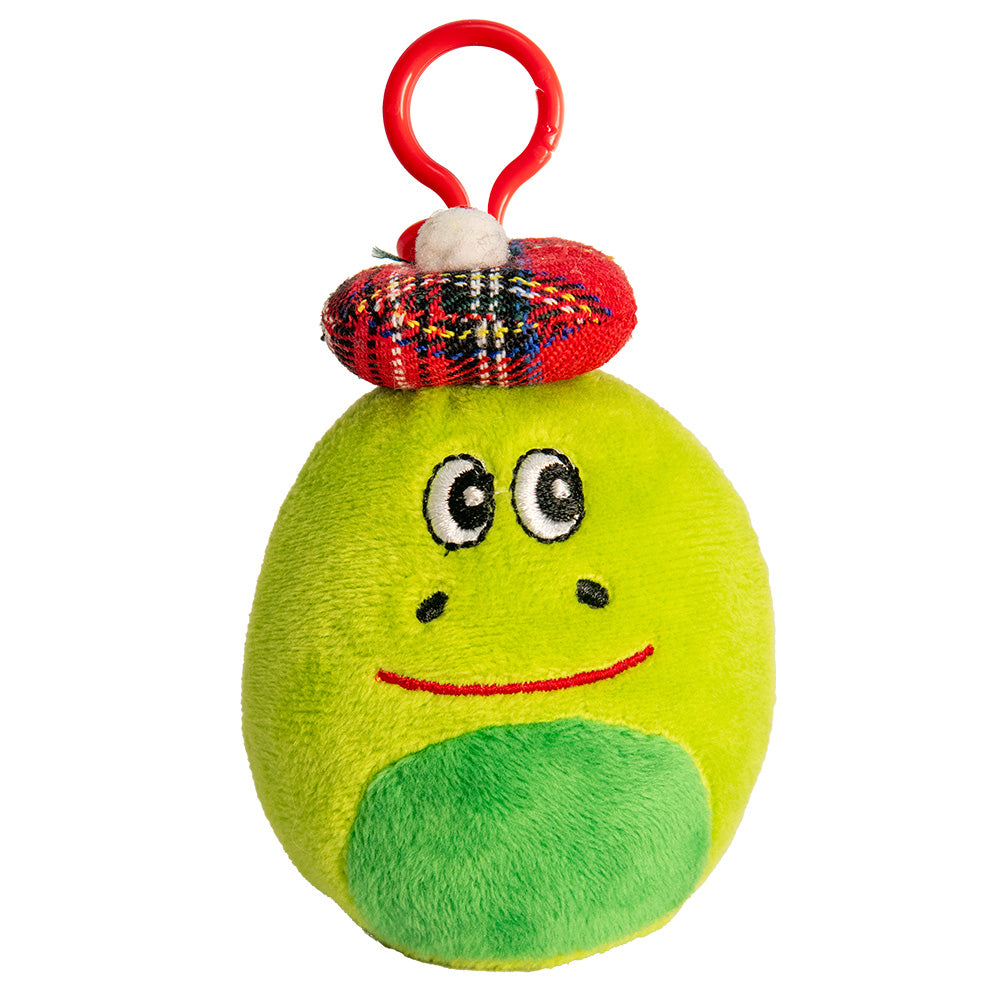 Green plush nessie toy with a face and red clip on a white background.