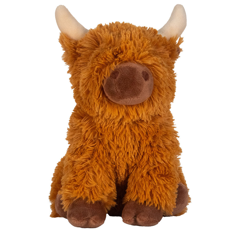 Plush toy cow with brown fur and white horns on a white background