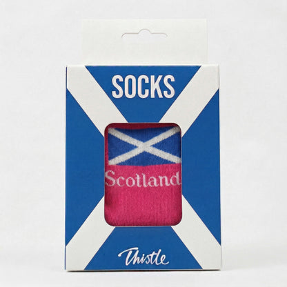 Packaged socks with Scottish flag design on a white background