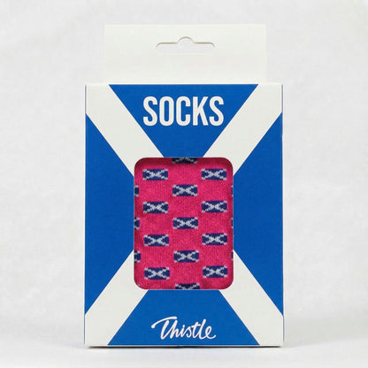 Packaged socks with Scottish flag pattern on a blue and white striped background
