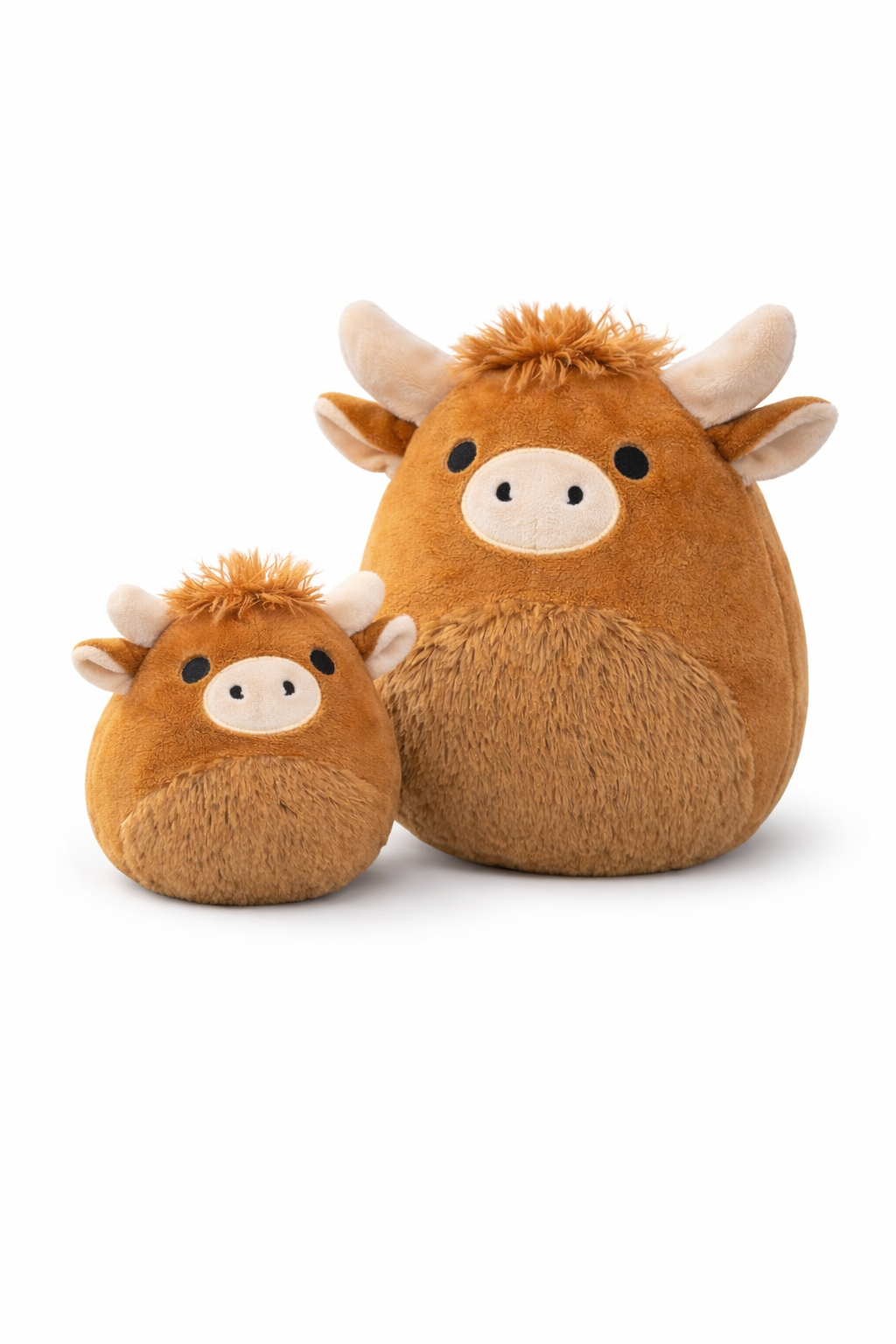 Two brown plush toys resembling Highland cows on a white background