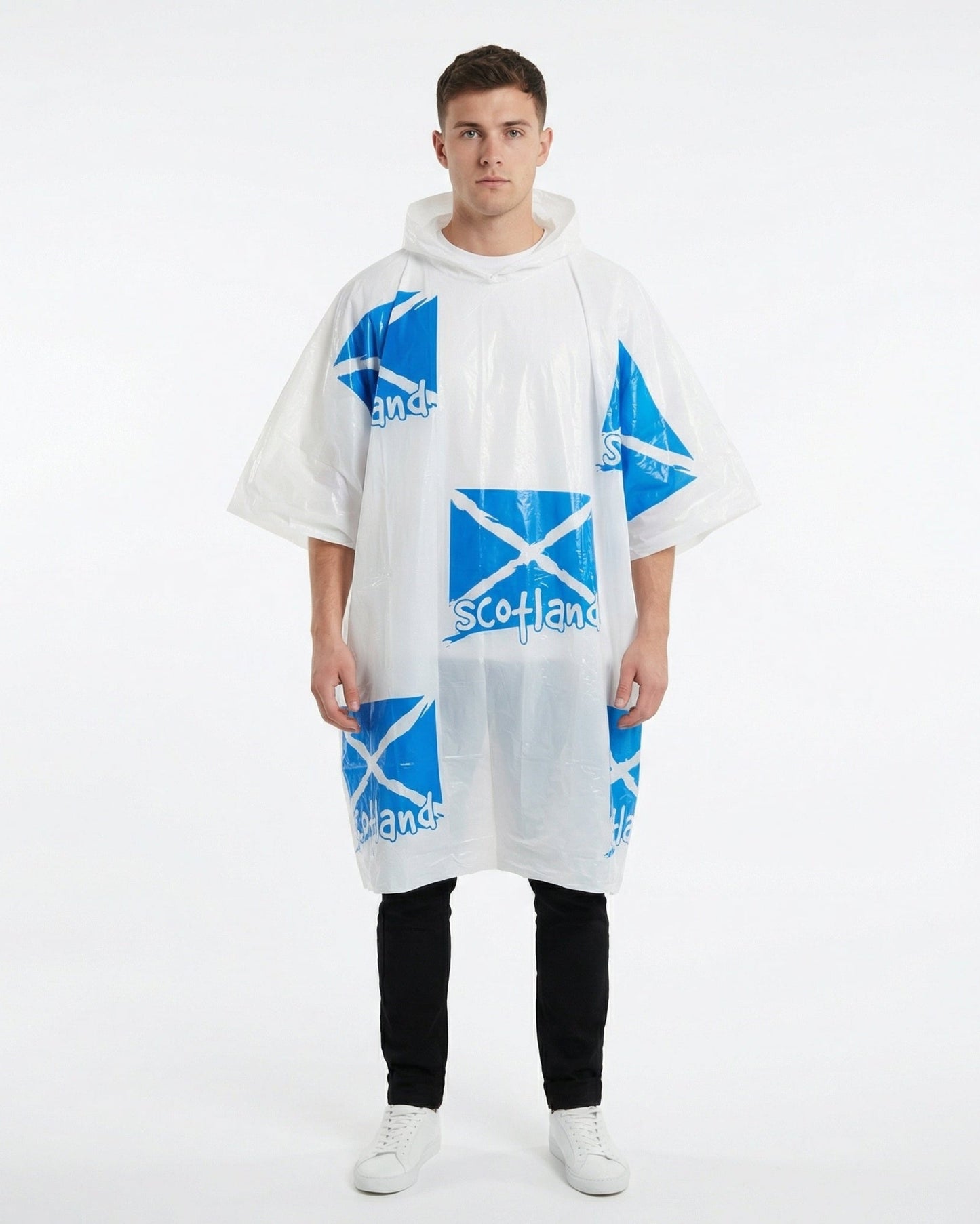 Man wearing jeans and a tshirt with a white rain poncho with scotland flags on over the top of his outfit