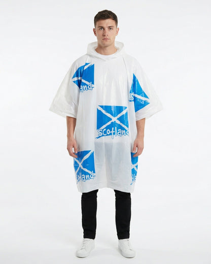 Man wearing jeans and a tshirt with a white rain poncho with scotland flags on over the top of his outfit
