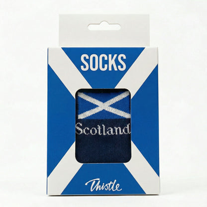 Packaged socks with Scottish flag design on a white background