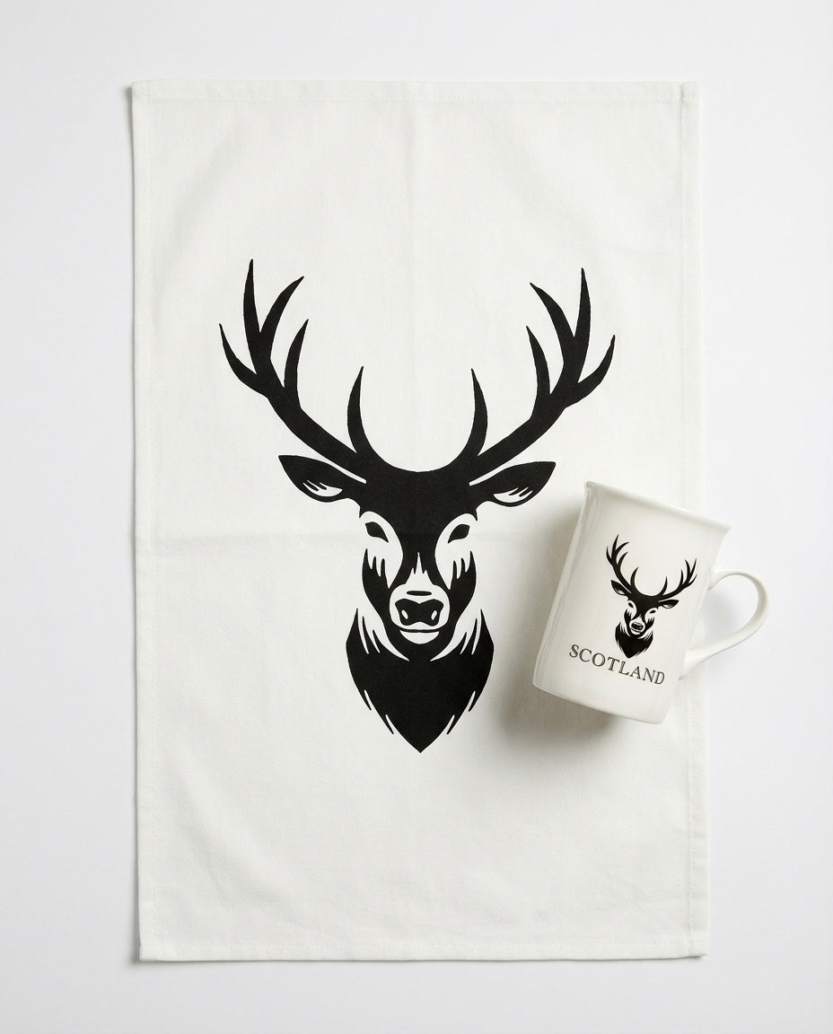 Tea towel with deer design and mug on a white background