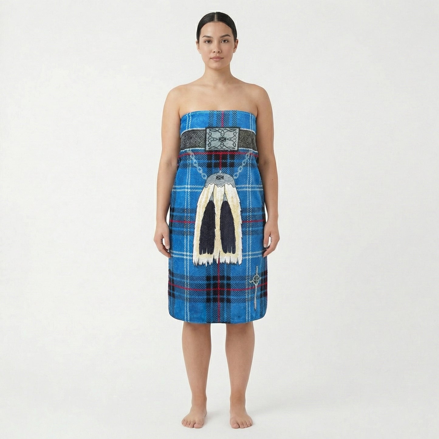 Woman wearing a wearing blue kilt beach towel with traditional sporran, on a white background.