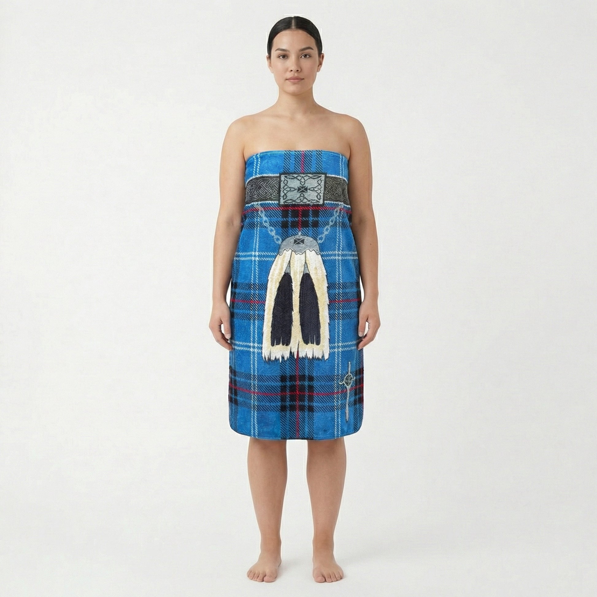 Woman wearing a wearing blue kilt beach towel with traditional sporran, on a white background.